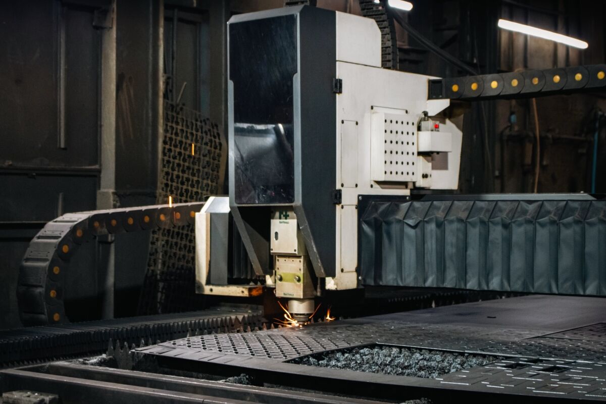 Industrial CNC laser cutter working on a steel sheet